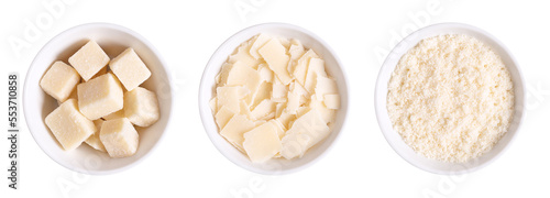 Grana Padano cheese, chunks, flakes and grated, in white bowls. Italian hard cheese, similar to Parmesan, with a savory flavor and a crumbly, slightly gritty texture, made from unpasteurized cow milk. photo