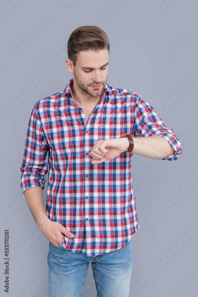 handsome man check time on watch isolated on grey background. man check time on watch