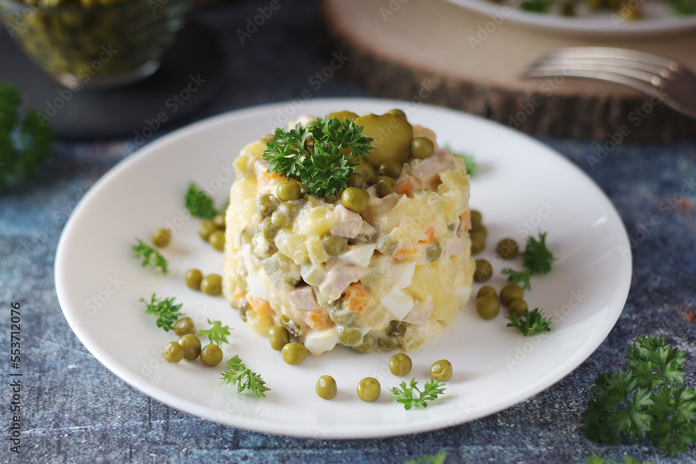 Olivier salad, traditional Russian dish, served on the plate Olivier salad, traditional Russian dish, served on the plate