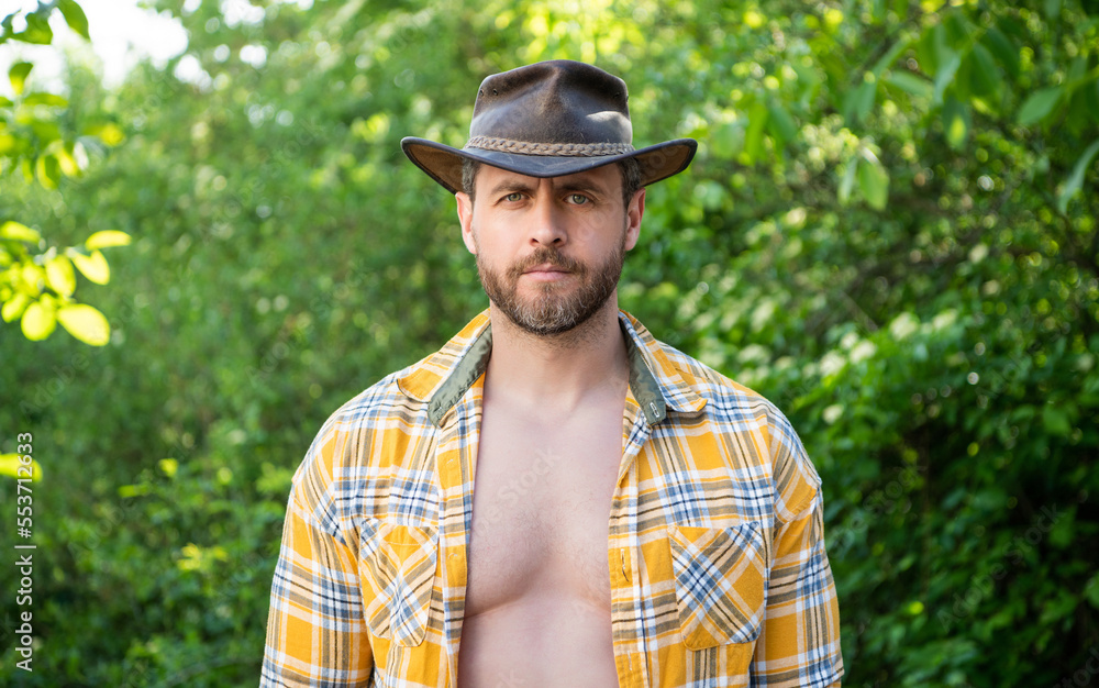 man in cowboy hat. sexy man in checkered shirt. western man wearing hat