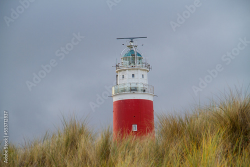 The lighthouse Eierland on the Dutch island Texel in the Wadden sea  the lower part hidden by a dune