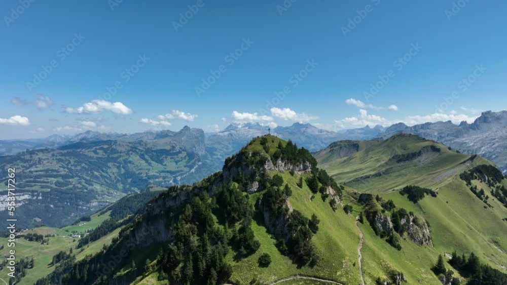 Mountain aerial, alps in switzerand in summer time. Hiking paradise and cross on top of the mountain. Peak and green summer landscape. Touristic destination in Europe. Aerial drone. Mountain aerial, alps in switzerand in summer time. Hiking paradise and cross on top of the mountain. Peak and green summer landscape. Touristic destination in Europe. Aerial drone.