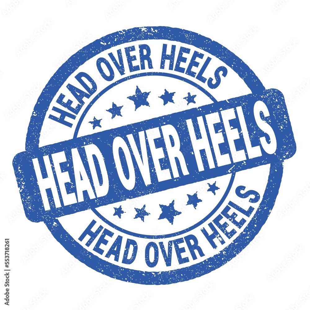 HEAD OVER HEELS text written on blue round stamp sign. HEAD OVER HEELS text written on blue round stamp sign.