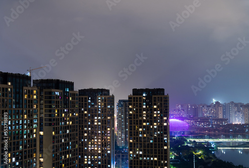 Modern apartments and unfinished building in the city at night