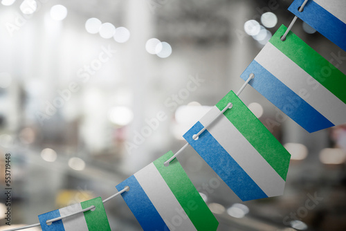 A garland of Sierra Leone national flags on an abstract blurred background photo