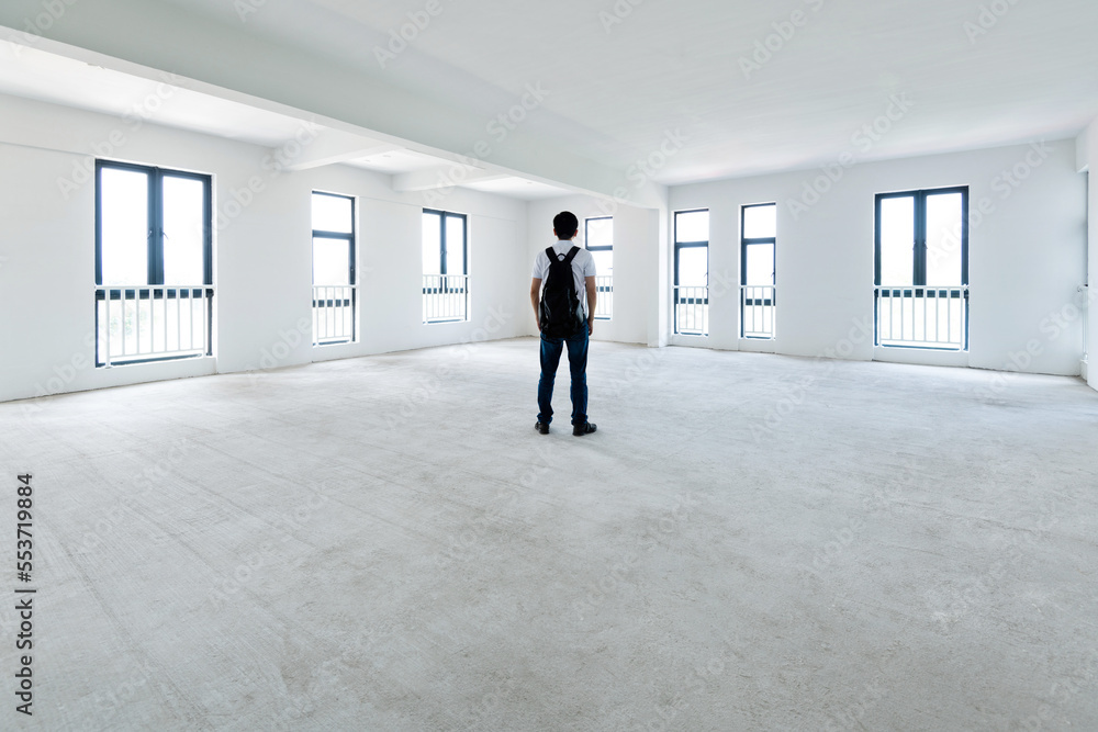 A man standing in empty office A man standing in empty office