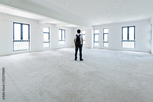 A man standing in empty office © xy