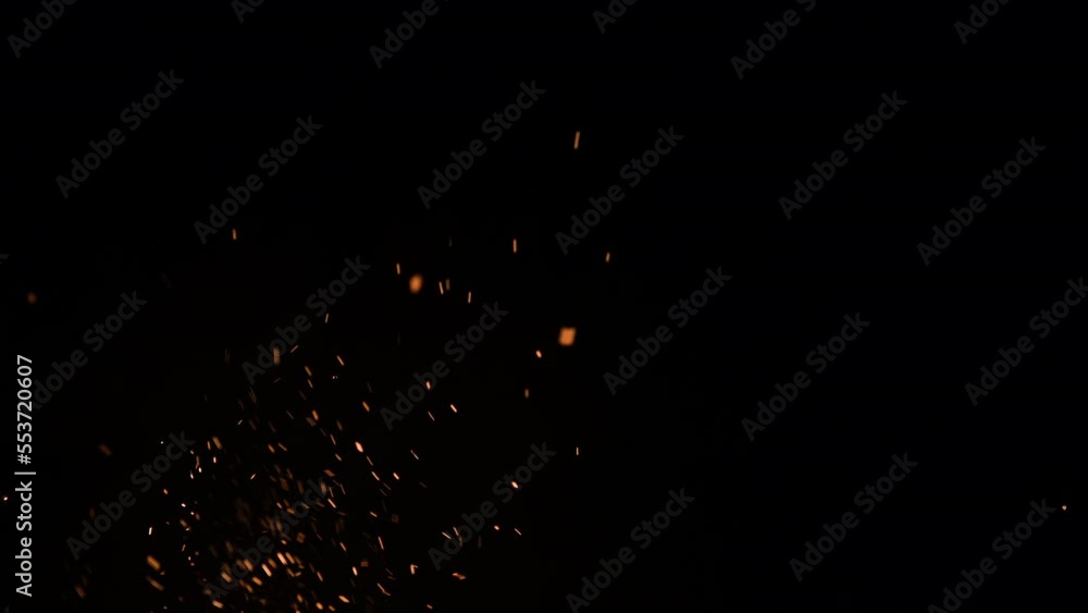 Fire sparks rising up isolated on black background. 4K resolution slow motion video of fiery orange glowing flying ember burning ash particles Fire sparks rising up isolated on black background. 4K resolution slow motion video of fiery orange glowing flying ember burning ash particles