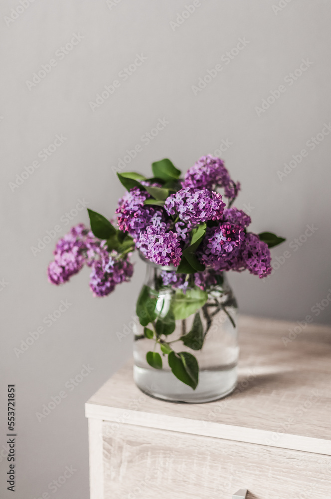 A bouquet of fresh lilacs in a glass vase top view. A bouquet of fresh lilacs in a glass vase top view.