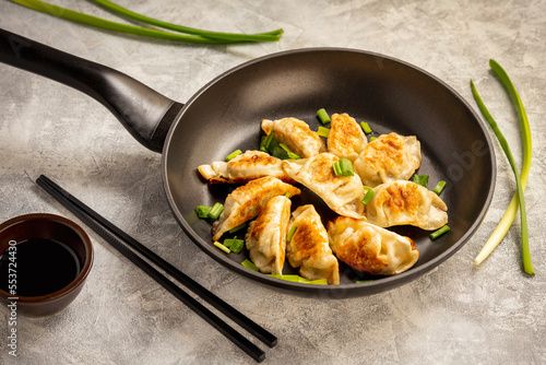 Gyoza, japanese pan-fried dumplings, on light background. 