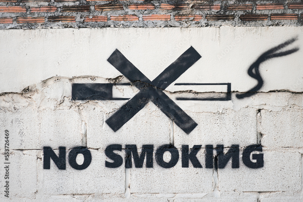 "No Smoking" decale symbol icon on the concrete wall in the public