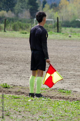 soccer referee, standing with a pennant in his hand photo