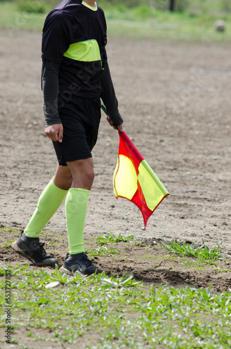 soccer referee with the colored pennant. linesman in a football game