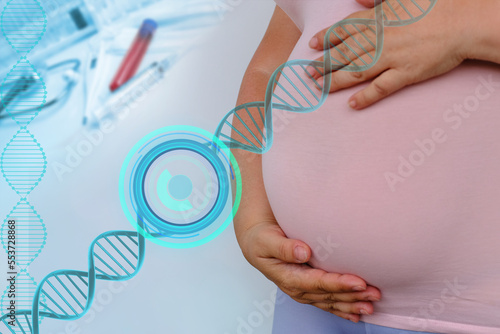 middle-aged pregnant woman in pink t-shirt holding her belly, waiting for newborn, concept of pregnancy reproduction, in vitro fertilization, planning late pregnancy after 40 years, selective focus