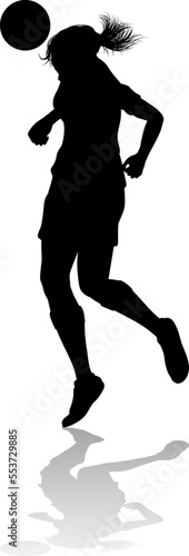 A female soccer football player woman in silhouettes