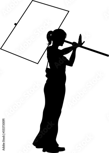 Protestor or demonstrator at a demonstration march, picket line or strike protest rally in silhouette. Holding up a banner or picket sign board placard.