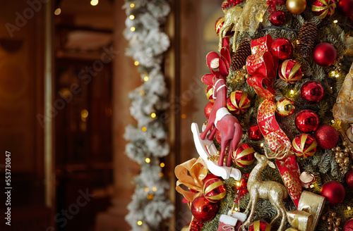 Christmas postcard. Detail view of a beautiful premium luxury decorated Christmas tree with tiny globes and toys.