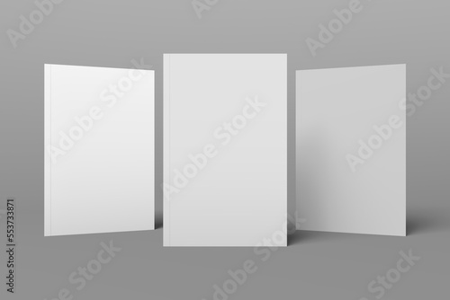 3 book models standing upright on a gray background. 3d realistic render soft cover book mockup. Mockup of book with white cover on isolated background.
