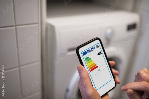 Person checking energy labels on phone photo