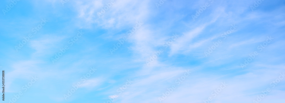 soft wide blue sky background with fluffy ciouds