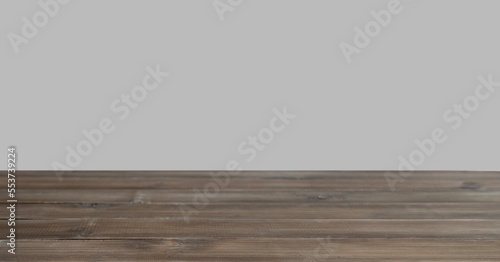 Dark wooden countertop with free space for installing the product or layout on the beige background.