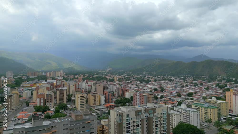 Aerial view of Maracay city on cloudy weather. The capital of the state of Aragua, Venezuela. The Caribbean town is surrounded by mountains Aerial view of Maracay city on cloudy weather. The capital of the state of Aragua, Venezuela. The Caribbean town is surrounded by mountains