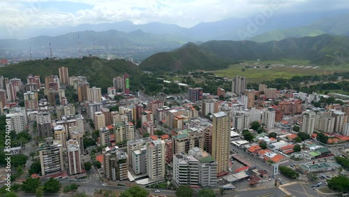 Aerial orbit view of Maracay city in north-central Venezuela. The capital of the state of Aragua. The Caribbean town is surrounded by mountains photo