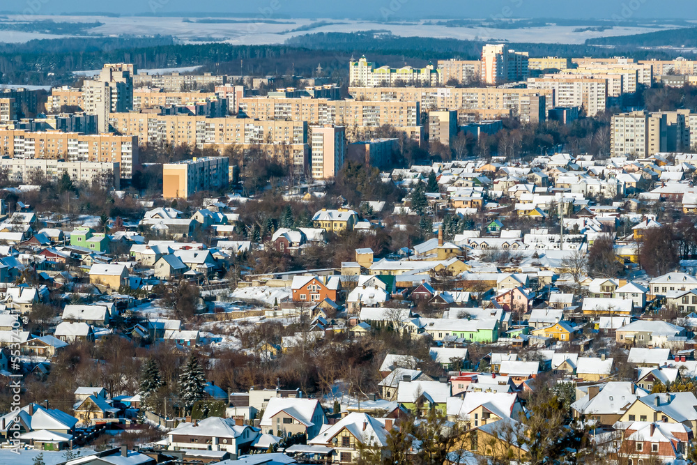 winter panoramic aerial view of a huge residential complex with high-rise buildings with snow