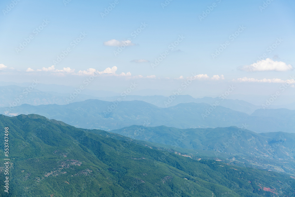 Aerial view of mountains covered with forests in summer