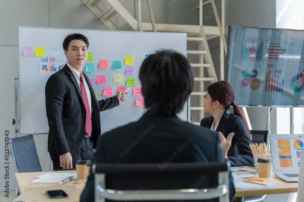 A group of young Asian businessmen Talking and planning work happily and have fun. at the company's office A group of young Asian businessmen Talking and planning work happily and have fun. at the company's office