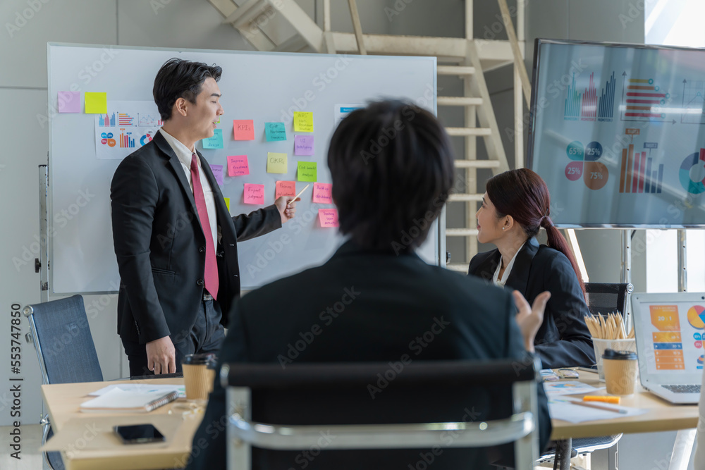A group of young Asian businessmen Talking and planning work happily and have fun. at the company's office A group of young Asian businessmen Talking and planning work happily and have fun. at the company's office