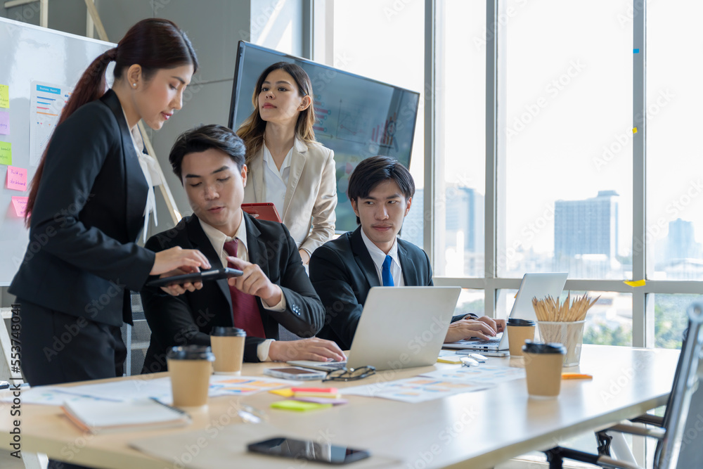 A group of young Asian businessmen Talking and planning work happily and have fun. at the company's office A group of young Asian businessmen Talking and planning work happily and have fun. at the company's office