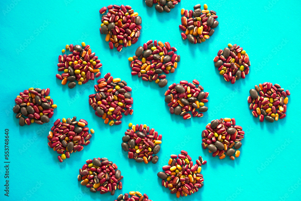 Assortment of many kinds of beans on blue background Assortment of many kinds of beans on blue background