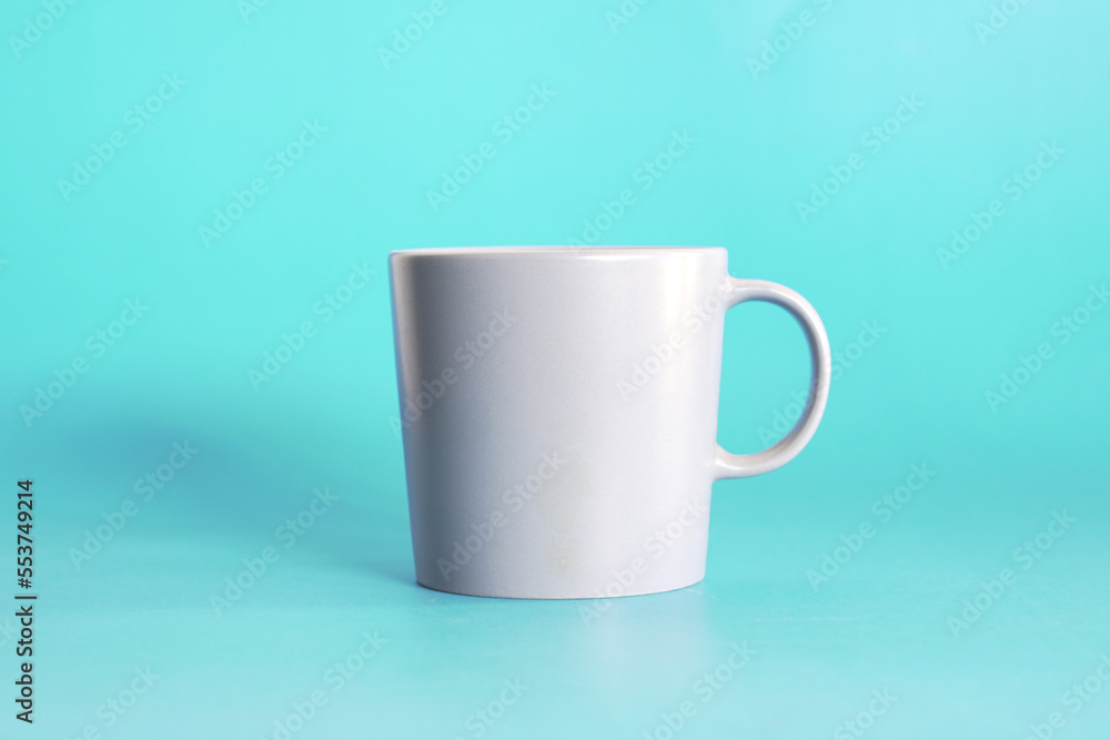 Fototapeta premium ceramic coffee cup on blue background, drink mug