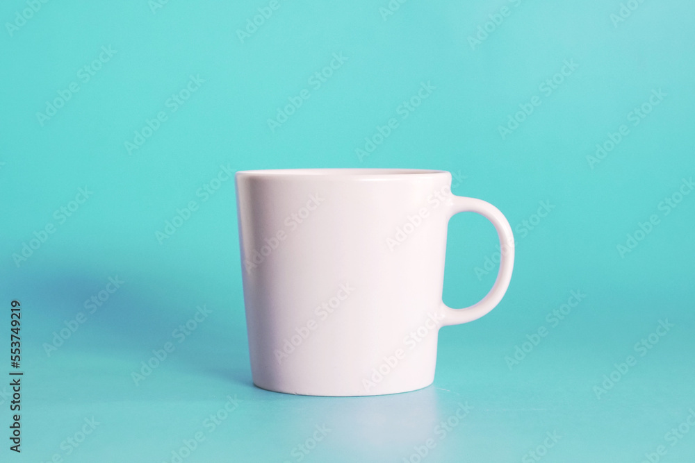 Fototapeta premium ceramic coffee cup on blue background, drink mug