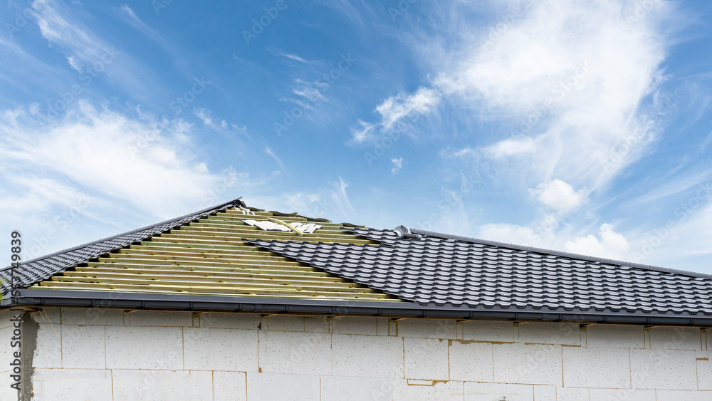 Obraz premium rooftop with metal tile on blue sky background