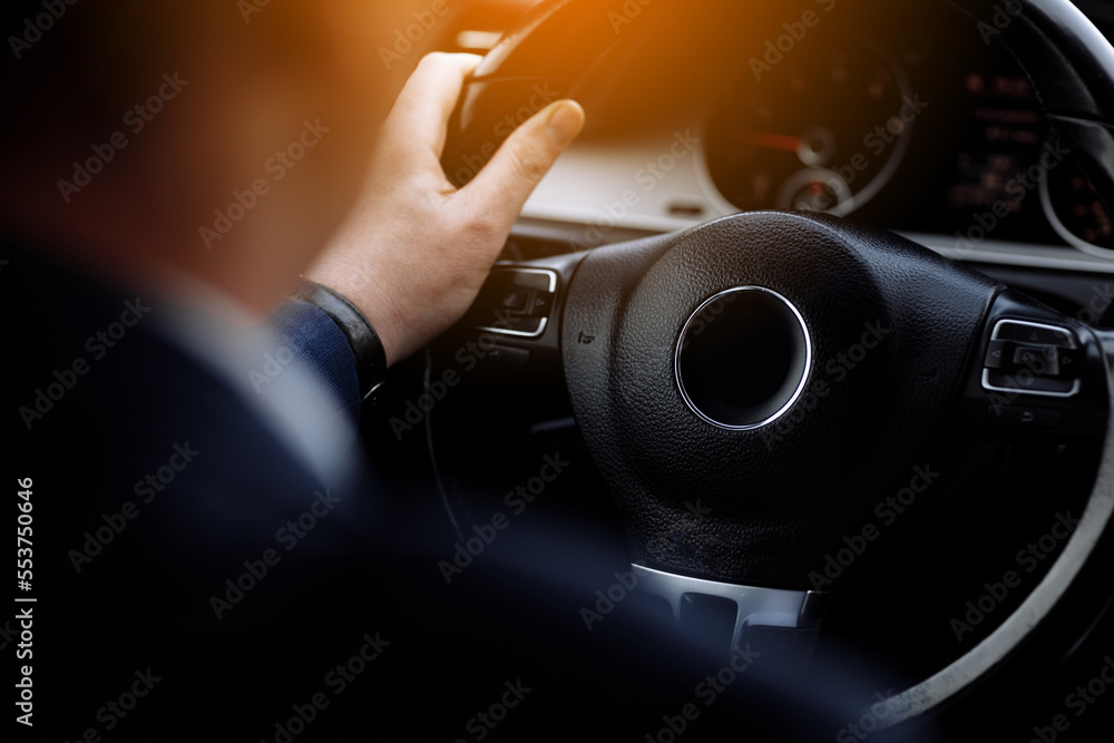 Cropped photo of arms businessman hands in classic white shirt and gold watch driving car hold wheel in new modern automobile vehicle black luxury rich salon Sale technology lifestyle concept. Cropped photo of arms businessman hands in classic white shirt and gold watch driving car hold wheel in new modern automobile vehicle black luxury rich salon Sale technology lifestyle concept.