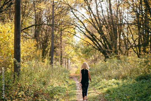 young girl walking in autumn park © andriyyavor