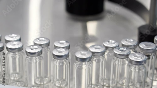 A conveyor line with moving glass ampoules.