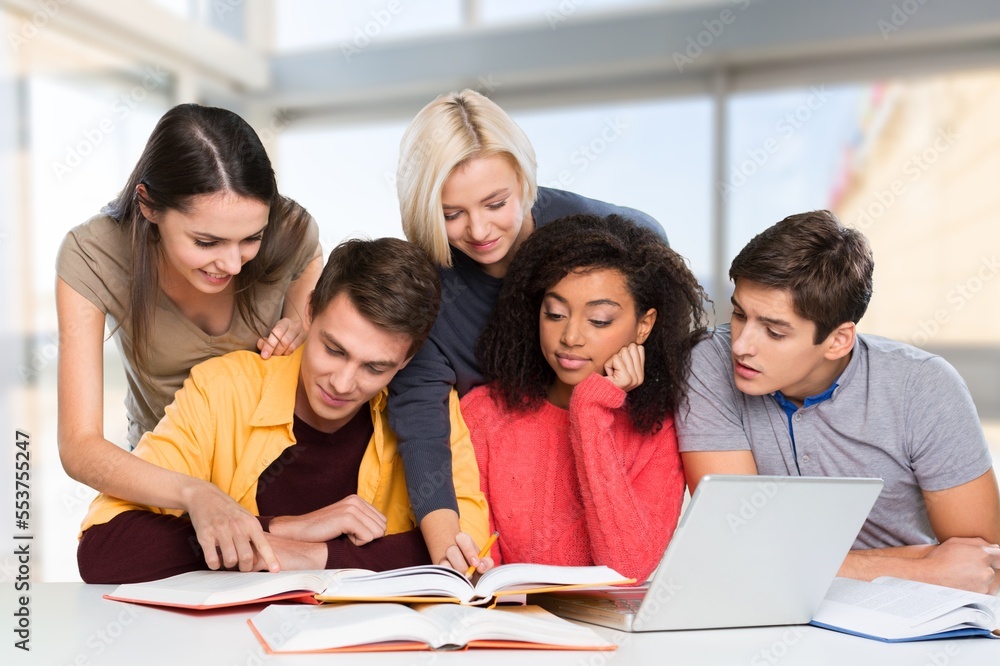 Young teacher helps students at university Young teacher helps students at university