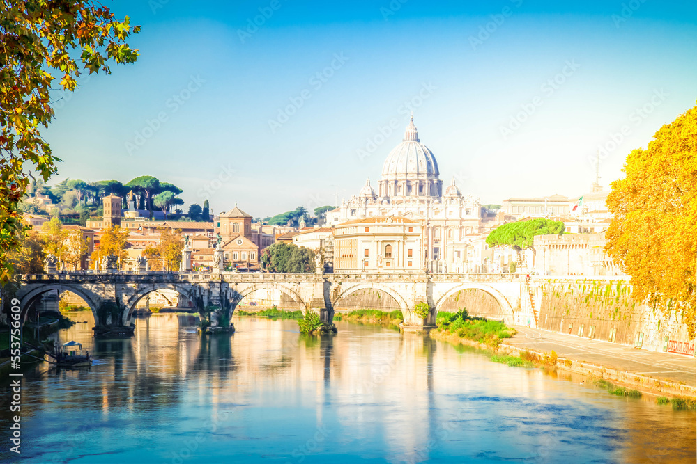 St. Peter's cathedral over bridge and Tiber river in Rome at sunset, Italy