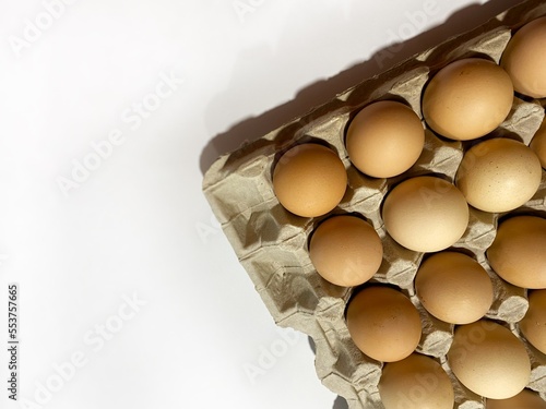 Chicken eggs in a package on a white background photo