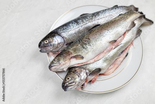 Fresh trout on the plate ready for preparing
