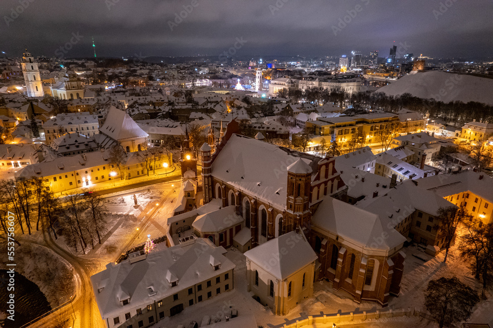 Aerial winter snowy night view of St. Anne's Church (Onos baznycia) Vilnius old town, Lithuania