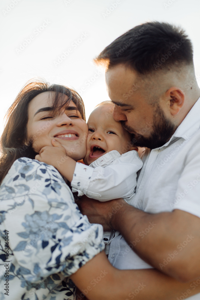 Happy young family spend time together outside in green nature Happy young family spend time together outside in green nature
