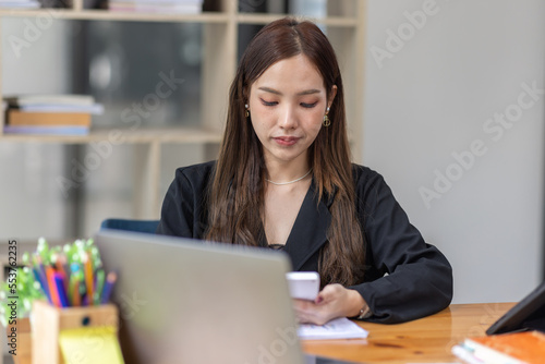 Portrait of business asian woman Accounting using calculating income-expenditure and analyzing real estate investment data report Financial and tax systems concept.	