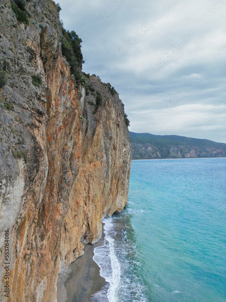 aerial photos of an isolated beach in Palinuro (south Italy). In the Campania region we find sandy beaches with cliffs overlooking the sea where you can climb. Photo taken on a cloudy day.
