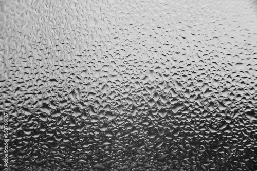 Texture on the window made of condensation and water drops.