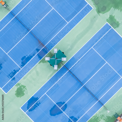 Drone View of a set of tennis courts in square format in a unique composition and view on the game.