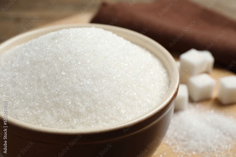 Granulated sugar in bowl on table, closeup Granulated sugar in bowl on table, closeup